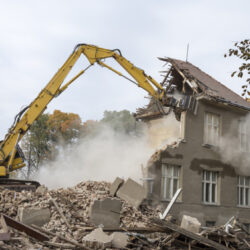 Digger demolishing houses