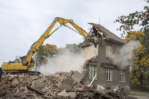 Digger demolishing houses