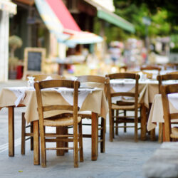 Small outdoor restaurants at the pedestrian area at center of Kalavryta town near the square and odontotos train station, Greece.