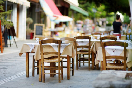 Small outdoor restaurants at the pedestrian area at center of kalavryta town near the square and odontotos train station, greece.