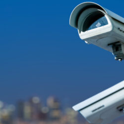 Security cctv camera monitoring system with panoramic view of a city on blurry background